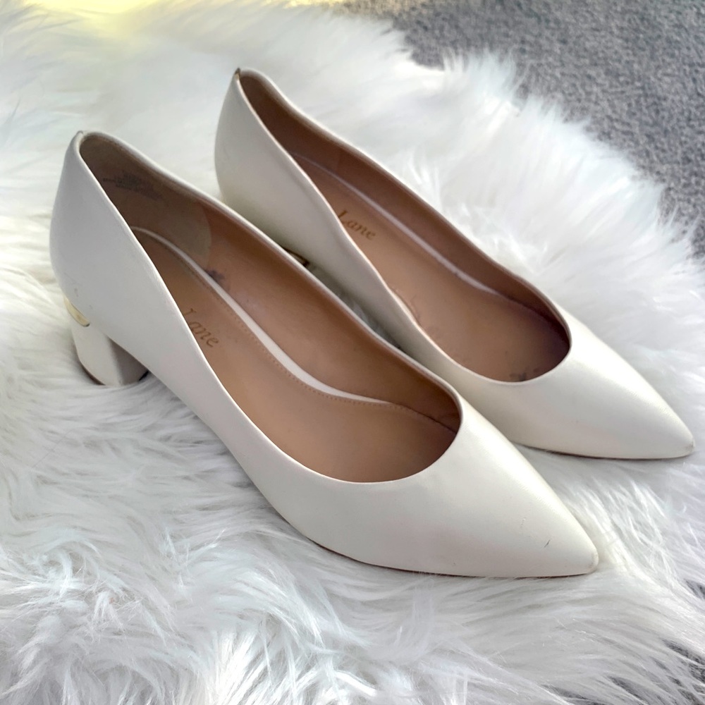 White kitten heels with metallic heel accent